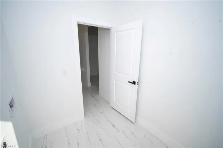 Spare room featuring baseboards