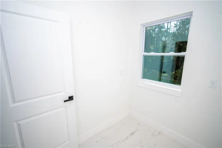 Empty room with baseboards and light marble finish flooring