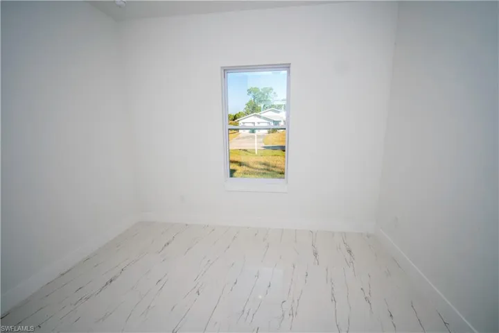 Unfurnished room with baseboards