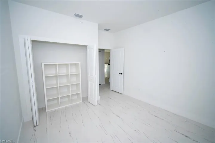 Unfurnished bedroom featuring a closet and baseboards