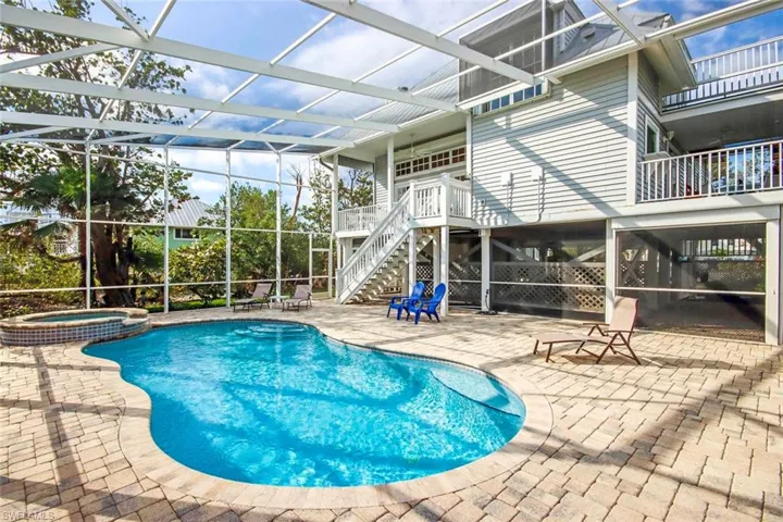 View of pool featuring a lanai, an in ground hot tub, and a patio