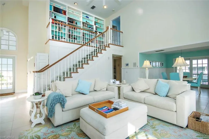 Living room with a high ceiling and light tile patterned floors
