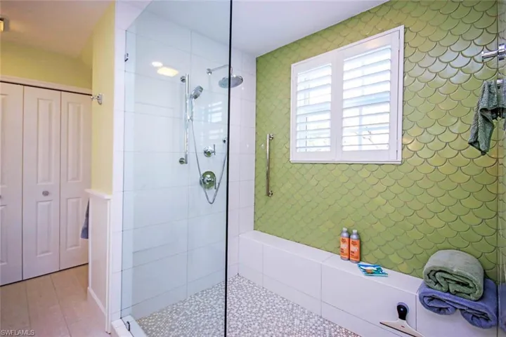 Bathroom featuring a tile shower and tile patterned floors
