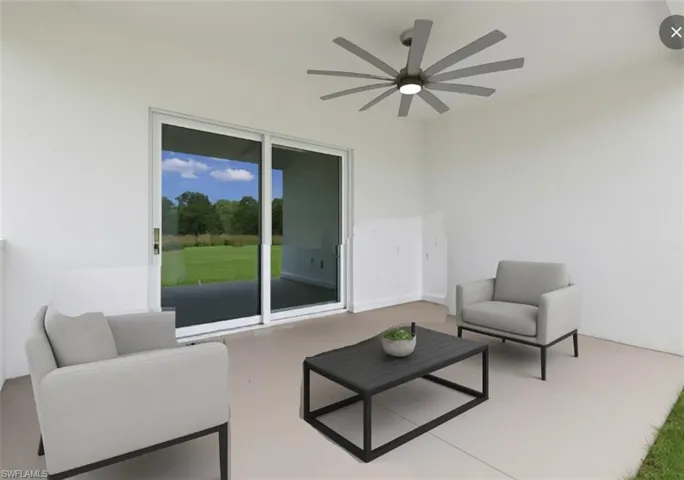 View of patio with a ceiling fan and an outdoor hangout area