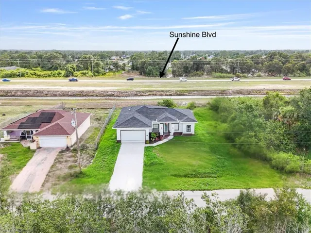 View from above of property with a tree filled landscape