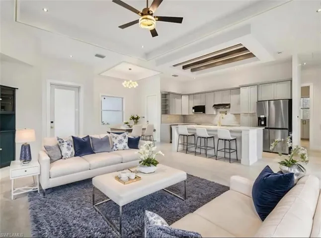 Living room featuring a ceiling fan and recessed lighting