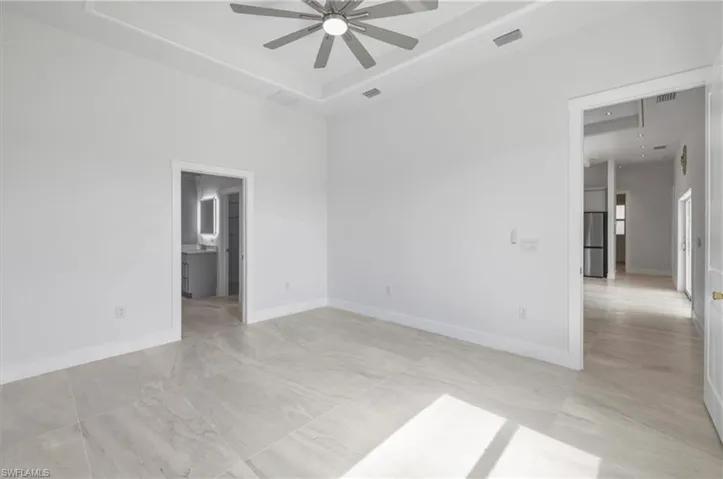 Master Bedroom featuring a ceiling fan, baseboards, and a tray ceiling