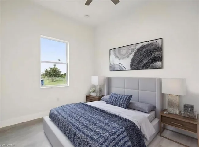 Bedroom featuring wood finished floors, ceiling fan, and baseboards