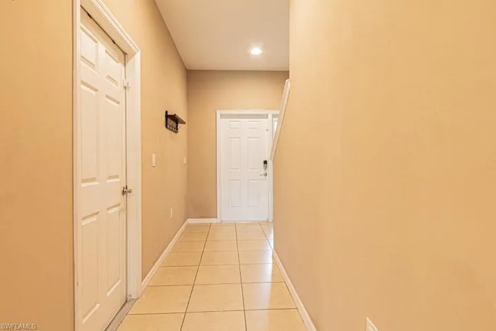 Corridor with light tile patterned floors