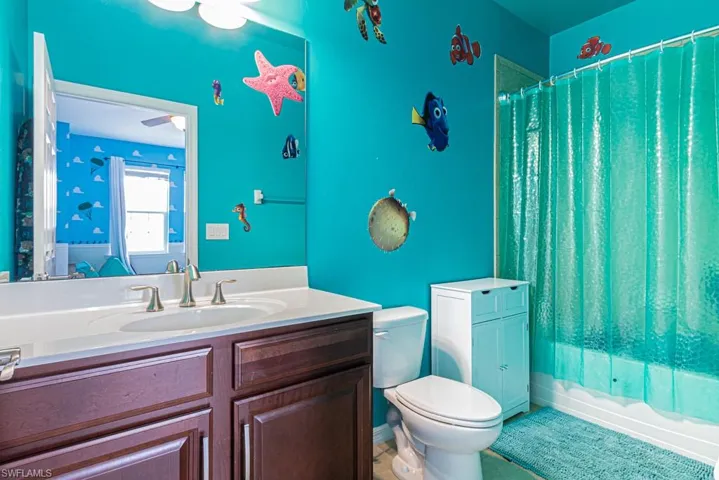 Bathroom with vanity, toilet, and tile patterned flooring