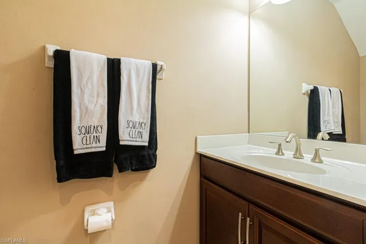 Bathroom featuring vanity and vaulted ceiling