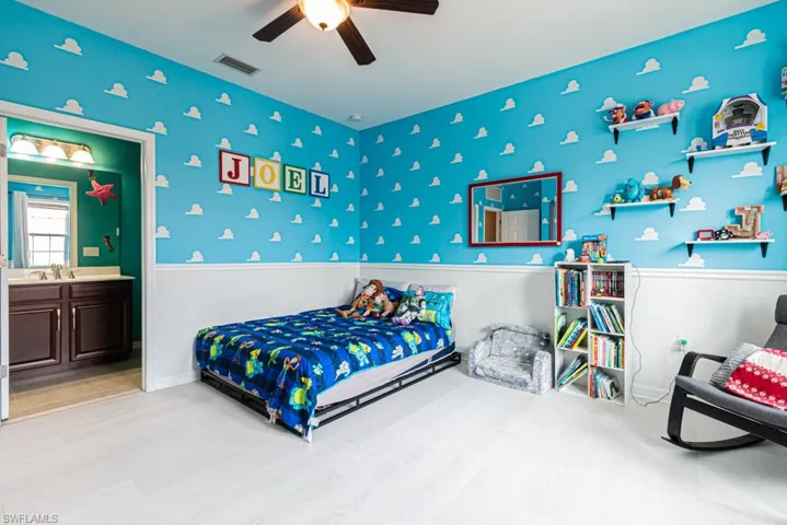 Bedroom featuring sink, ensuite bathroom, ceiling fan, and light hardwood / wood-style floors