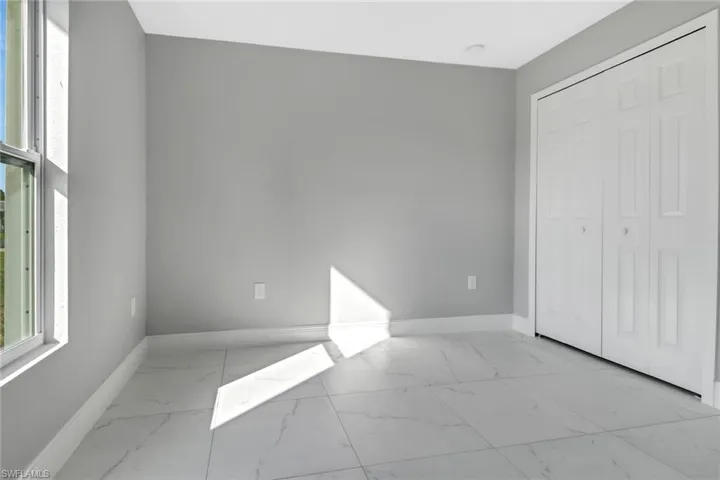 Unfurnished bedroom with a closet