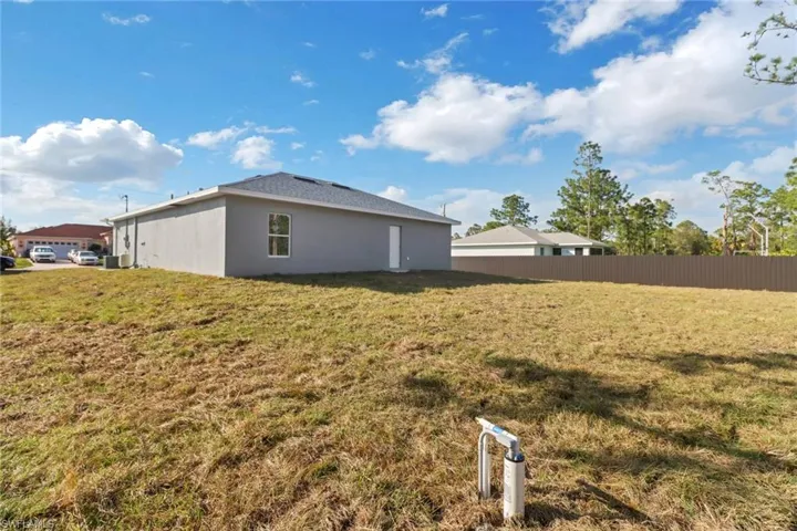 View of side of home featuring a lawn