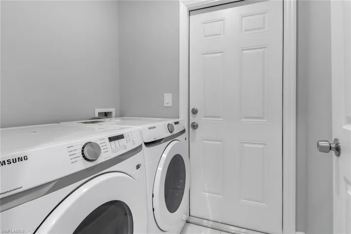 Washroom with washing machine and clothes dryer