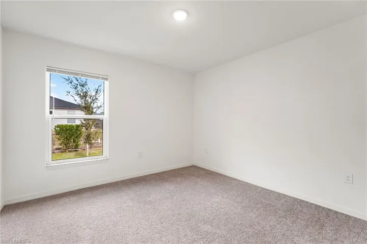 Spare room featuring carpet
