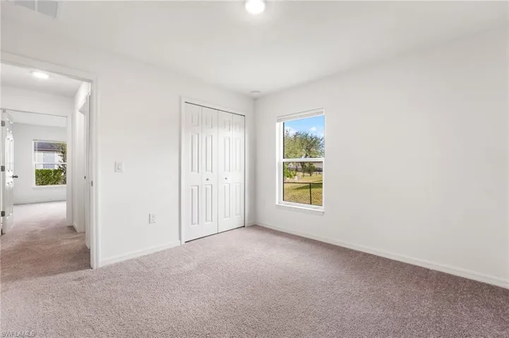 Unfurnished bedroom with carpet flooring and a closet