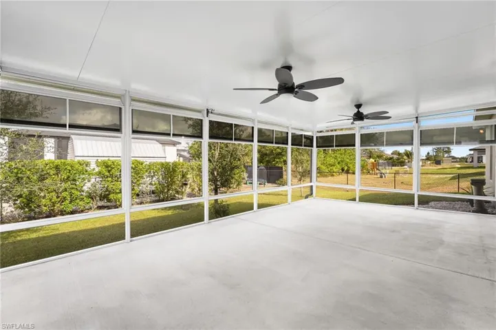 Unfurnished sunroom featuring ceiling fan