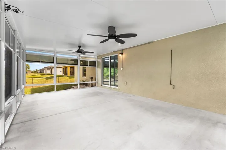 Unfurnished sunroom featuring ceiling fan