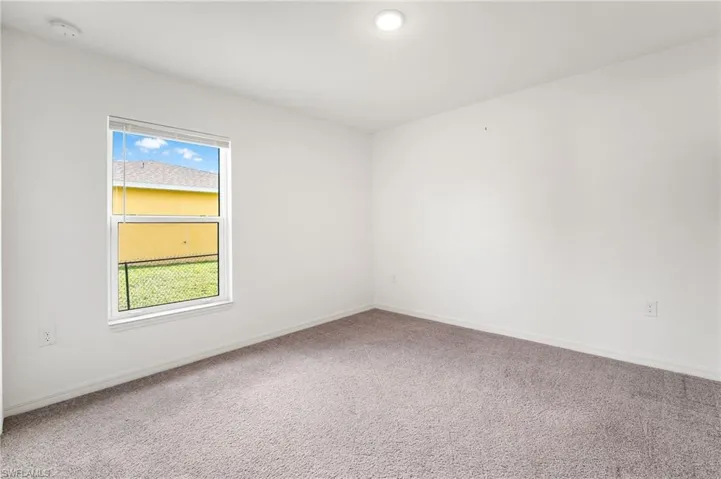 Carpeted spare room with plenty of natural light