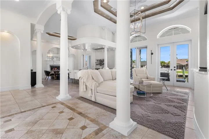 This open concept allows you to entertain large groups or intimate gatherings!Double tray ceilings, 3 sets of glass french doors open to your back lanai and out onto you dock area!
