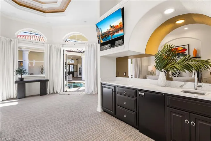 Master Ensuite Kitchenette with Cambria Quartz, Cabinetry, Sink, Mirrored Wall, U-Line Fridge and Built in TV inlet.