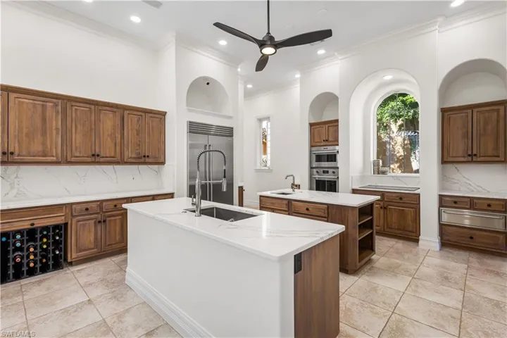 This Luxurious Chef/Butlers Dream Kitchen has it all! Cambria Quartz countertops throughout, 2 Center Islands with single sinks and Cabinetry with pull out drawers. Sub Zero Fridge and Freezer, Fisher/Paykel Dual Draw Dishwasher, 3 NEW Garbage Disposals, Built In WOLF oven and Microwave, Kitchen Aid Induction Top with Warming Drawers, Buffet Area, 30 Btl Wine Rack and a Built In TV Inlet above the OVERSIZED Walk In Pantry! Breakfast Nook with Bench Seating, Cambria Quartz Table Top with Courtyard Views!