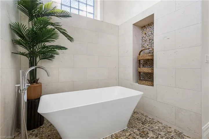Want to get the serenity and calmness of a spa without ever leaving your home? Relax and Soak in the Zen Soaking Tub surrounded by Pebble Stone Mosaic flooring and Tiled walls.