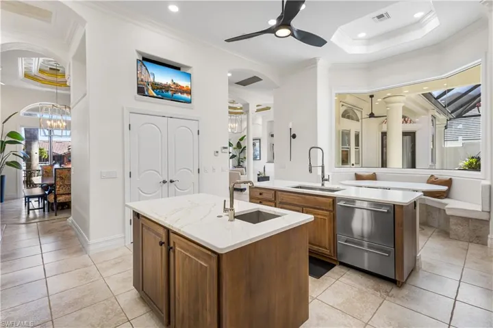 This Luxurious Chef/Butlers Dream Kitchen has it all! Cambria Quartz countertops throughout, 2 Center Islands with single sinks and Cabinetry with pull out drawers. Sub Zero Fridge and Freezer, Fisher/Paykel Dual Draw Dishwasher, 3 NEW Garbage Disposals, Built In WOLF oven and Microwave, Kitchen Aid Induction Top with Warming Drawers, Buffet Area, 30 Btl Wine Rack and a Built In TV Inlet above the OVERSIZED Walk In Pantry! Breakfast Nook with Bench Seating, Cambria Quartz Table Top with Courtyard Views!