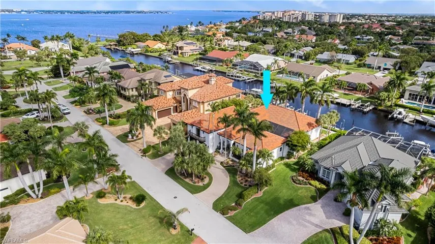 Birds eye view of property with a water view