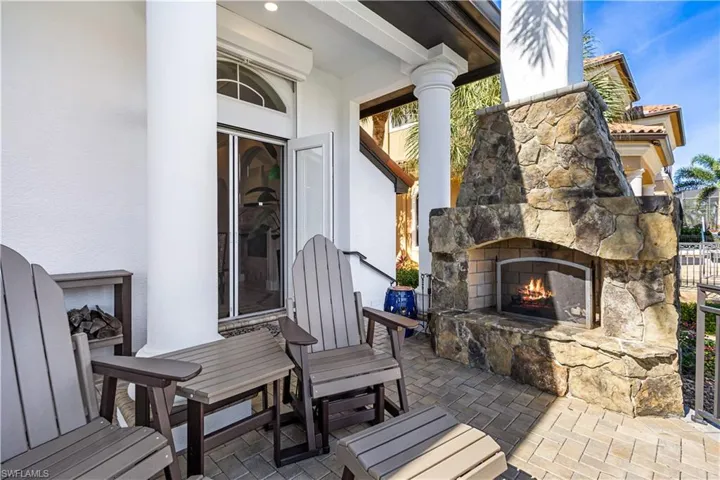 Outdoor Lanai with seating area by the Stone Wood Fireplace! Overlooking the canal and 8,000 lb Boat Lift and Piers along the 90ft Seawall fit for up to a 48ft Yacht!