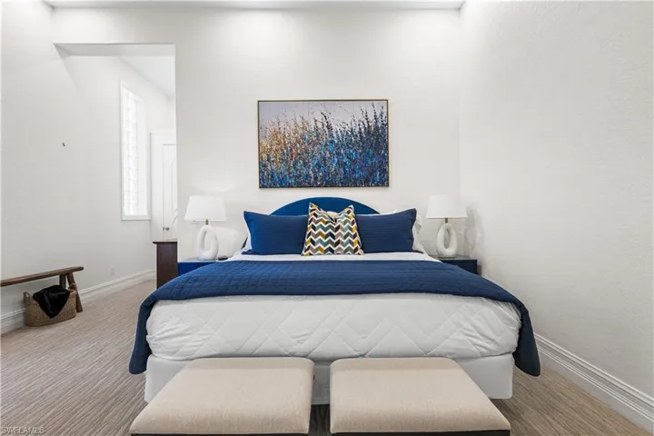 2nd Ensuite Bedroom with Double French Doors leading to the Courtyard. Coffered Ceiling, Transom Window, Carpet, Mirrored Wall and Closet. Built In TV Electronics Cabinet with a Cambria Quartz countertop.