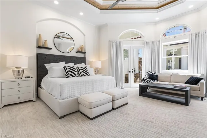 Primary suite has access to your pool, spa and lanai. Cozy seating area! Double tray  ceilings!