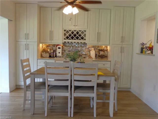 ABSOLUTELY GORGEOUS HIGH END ALL WOOD CABINETS, 2 PANTRIES WITH PULL OUT DRAWERS, BEAUTIFUL QUARTZ COUNTER, TILE BACKSPLASH, UNDER CABINET LIGHTING, BEVERAGE CHILLER.  THIS IS A HUGE UPGRADE AND ADDS SO MUCH BEAUTY TO THIS SPACE