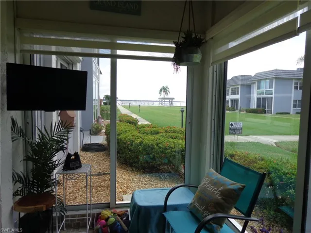 BEAUTIFUL, SUN ROOM OFF THE DINING ROOM.  THE DOORS ARE IMPACT RATED AND OPEN SO YOU CAN ENTER AND EXIT FROM THIS ROOM IF YOU LIKE.  THIS UNIT HAS HURRICANE SHUTTERS TOO!