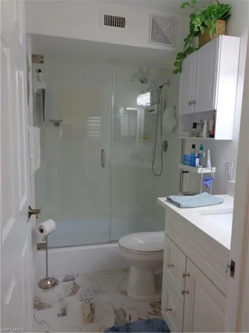 LOVELY MASTER BATHROOM WITH A FRAMLESS SHOWER DOOR, LUXURIOUS TILE FLOORING AND A VANITY WHICH OFFERS ADDITIONAL SPACE ON THE COUNTERTOP AS WELL AS DRAWERS FOR STORAGE