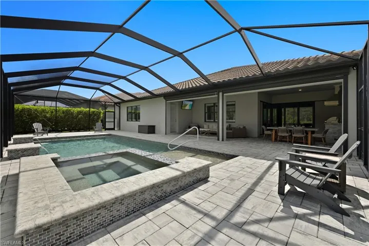 Rear view of property with a sunroom, a patio, a lanai, and stucco siding