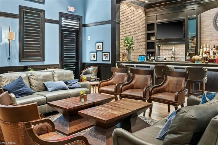 Building lobby with brick wall, a wainscoted wall, a decorative wall, and a towering ceiling