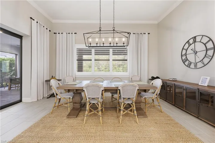 Dining room with ornamental molding and wood tiled floors