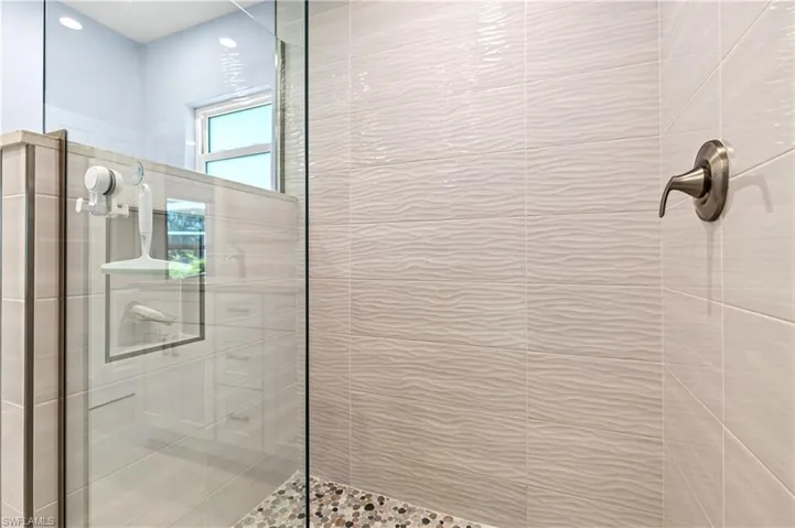 Full bath featuring tiled shower