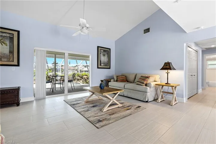 Living room with high vaulted ceiling and ceiling fan