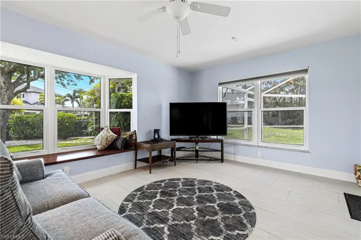 Living room featuring healthy amount of natural light and ceiling fan