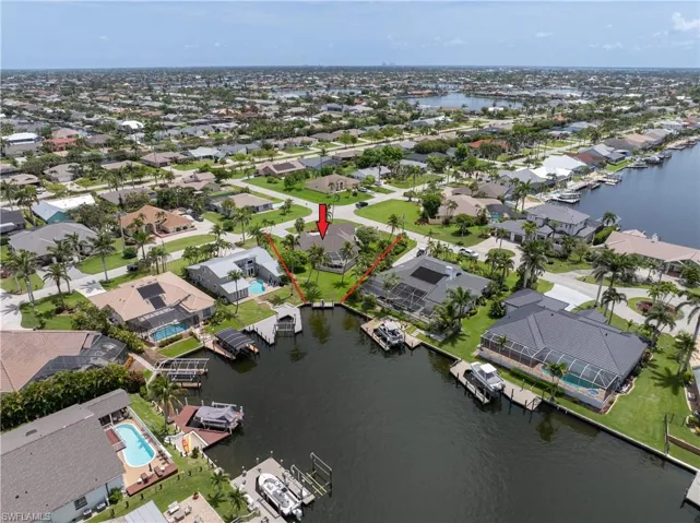 Aerial view of property's location with nearby suburban area