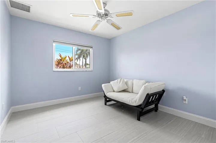 Sitting room featuring baseboards and a ceiling fan