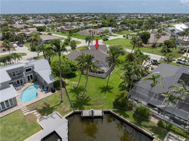 Aerial view of residential area featuring a pool