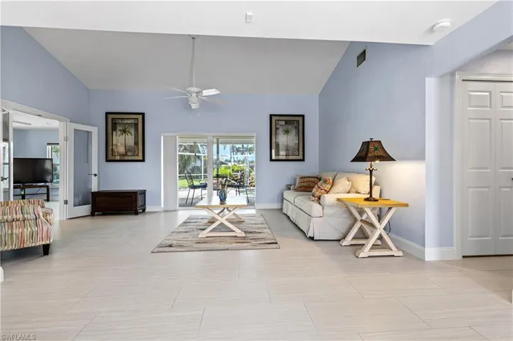 Living area featuring lofted ceiling and a ceiling fan