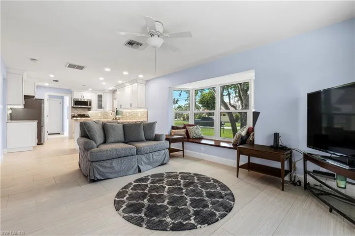 Living room featuring a ceiling fan, recessed lighting, and a desk