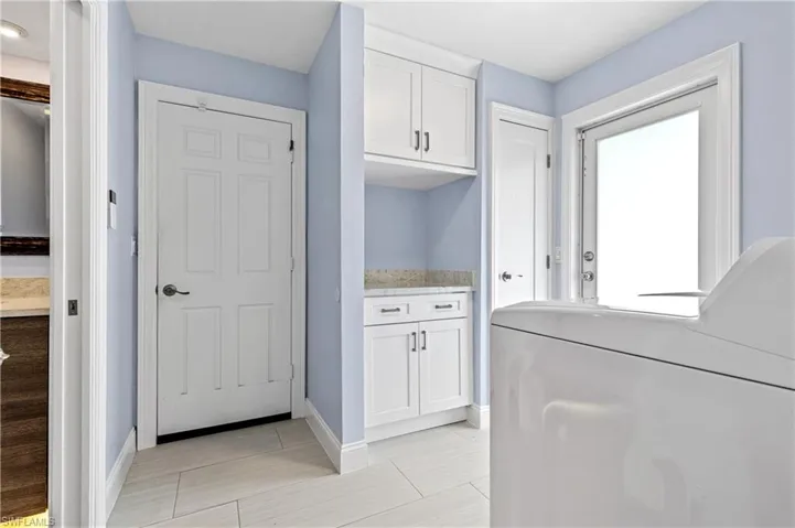 Laundry area featuring washer / dryer and baseboards