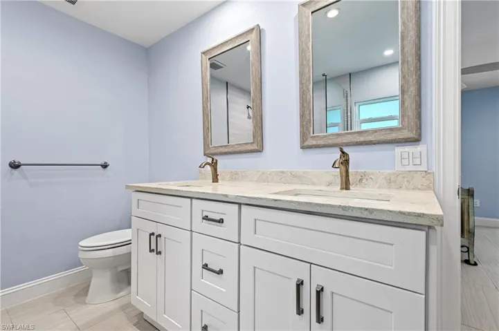 Bathroom with double vanity and recessed lighting