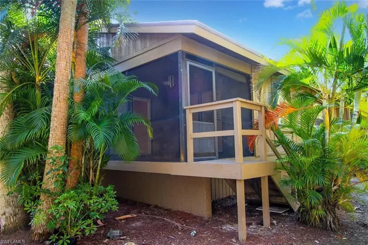 View of property exterior featuring a sunroom